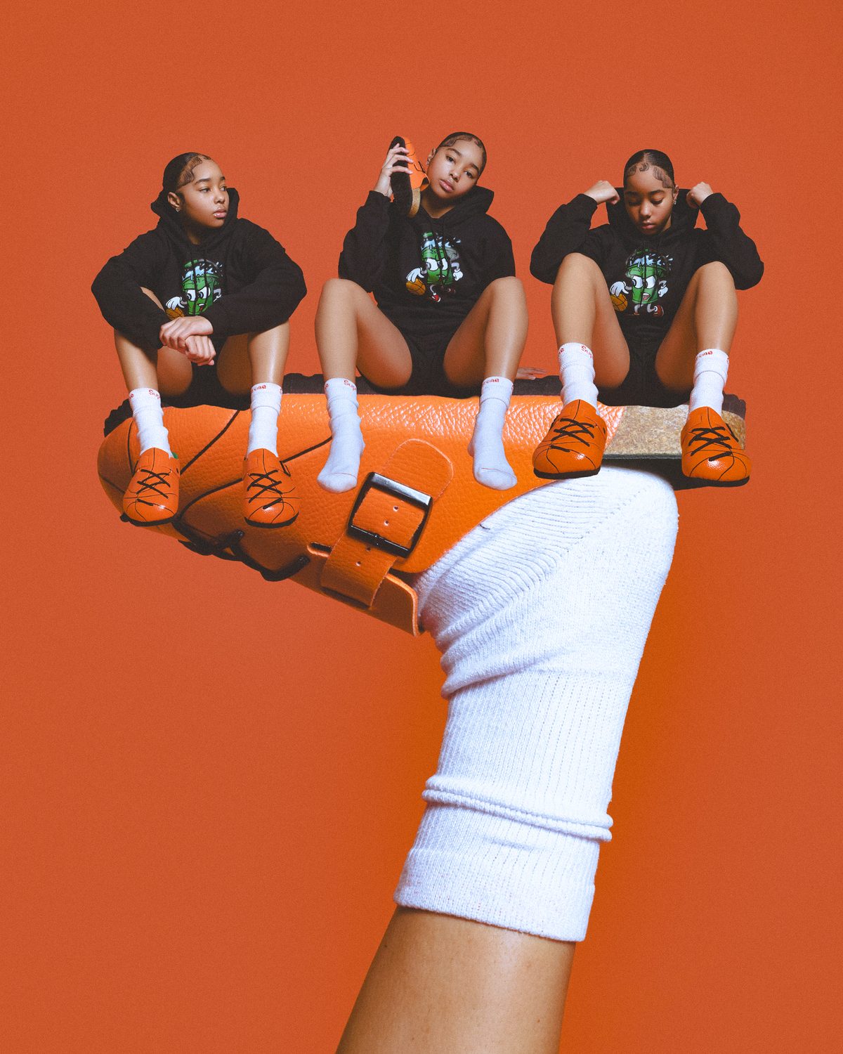 Three model portraits sitting on an oversized WB-001 clog